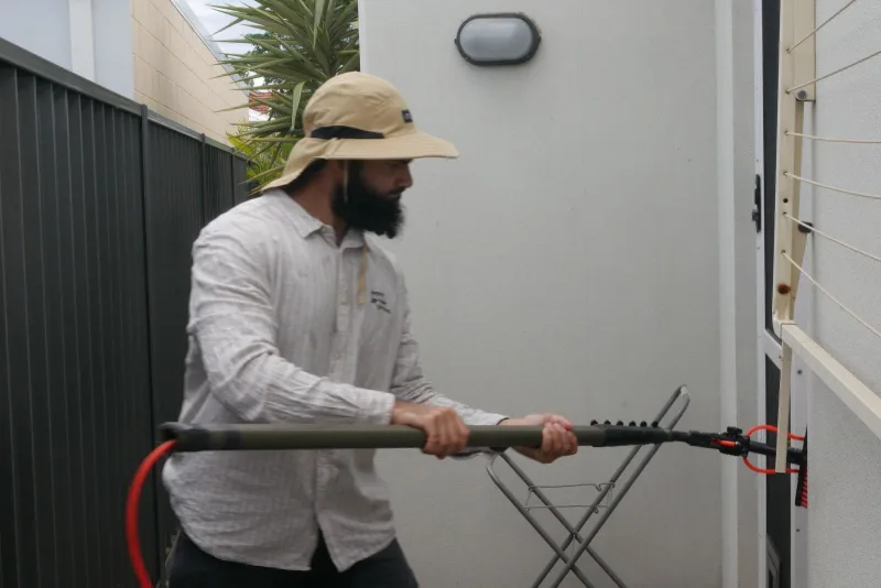 Technician cleaning solar panels in Perth