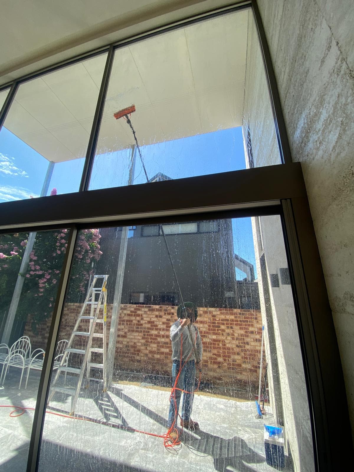 Technician cleaning residential home windows